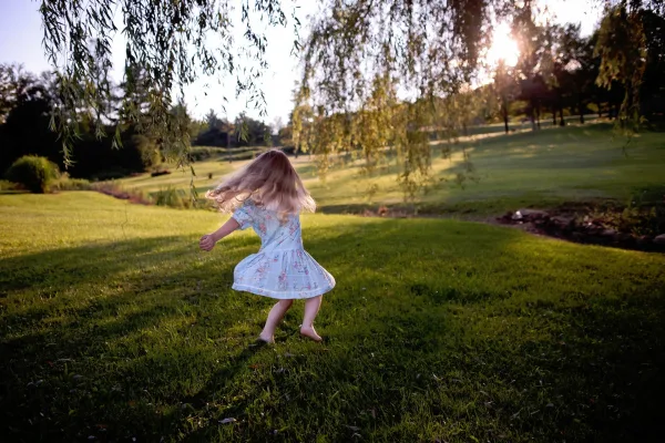 Little girl twirling outside