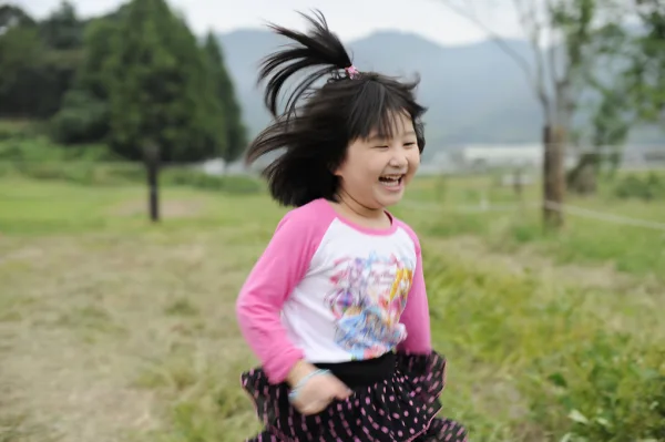 Child running outside laughing