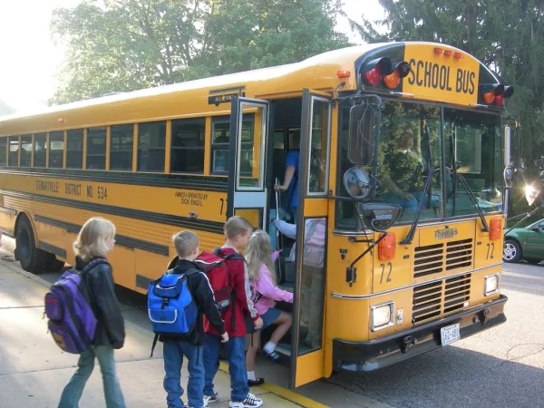 Kids getting on the school bus