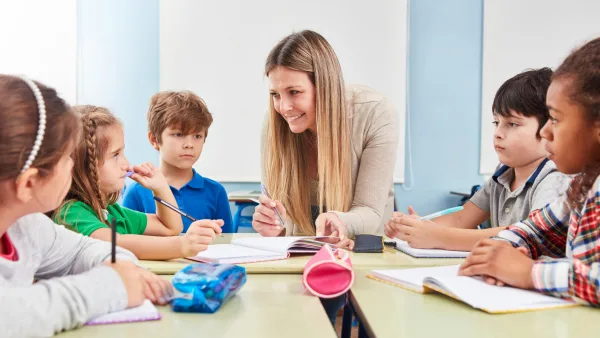 Adult teacher instructing children